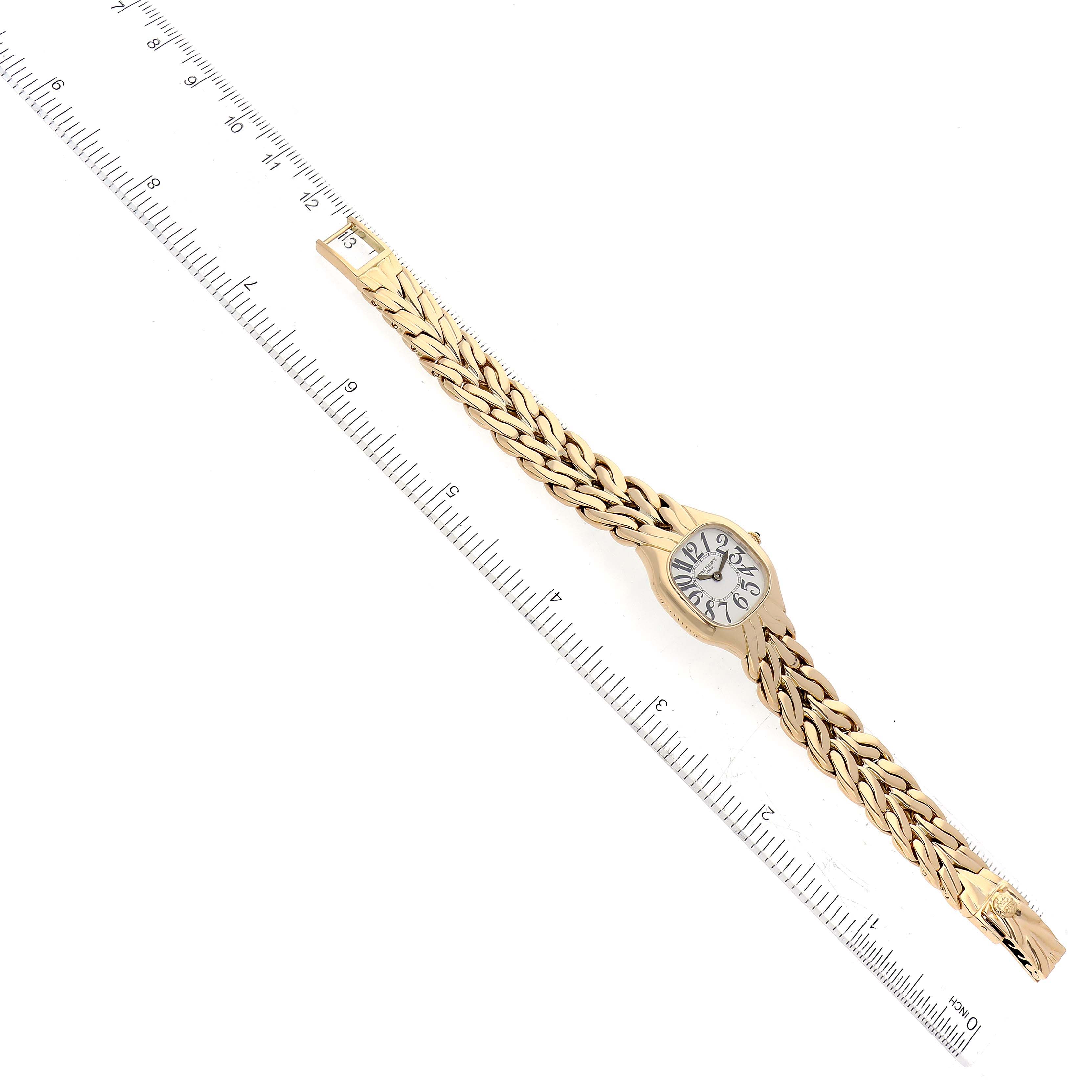 The image shows an overhead view of the La Flamme model by Patek Philippe with a ruler for scale.