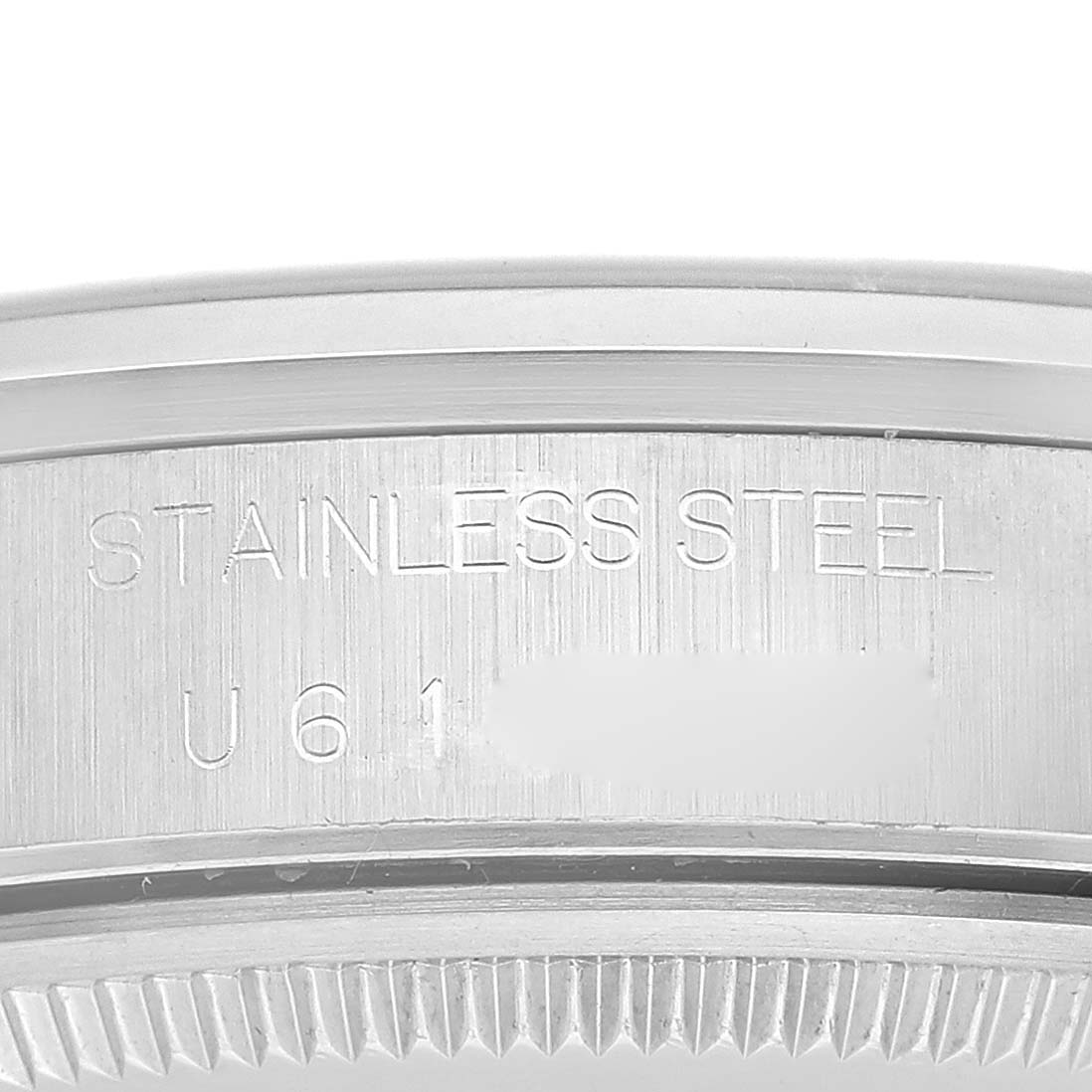The image shows a close-up of the stainless steel casing and engraved serial number of a Rolex Air-King 14000M Men's Stainless Steel Blue Dial 14000M Men's Stainless Steel Blue Dial watch.