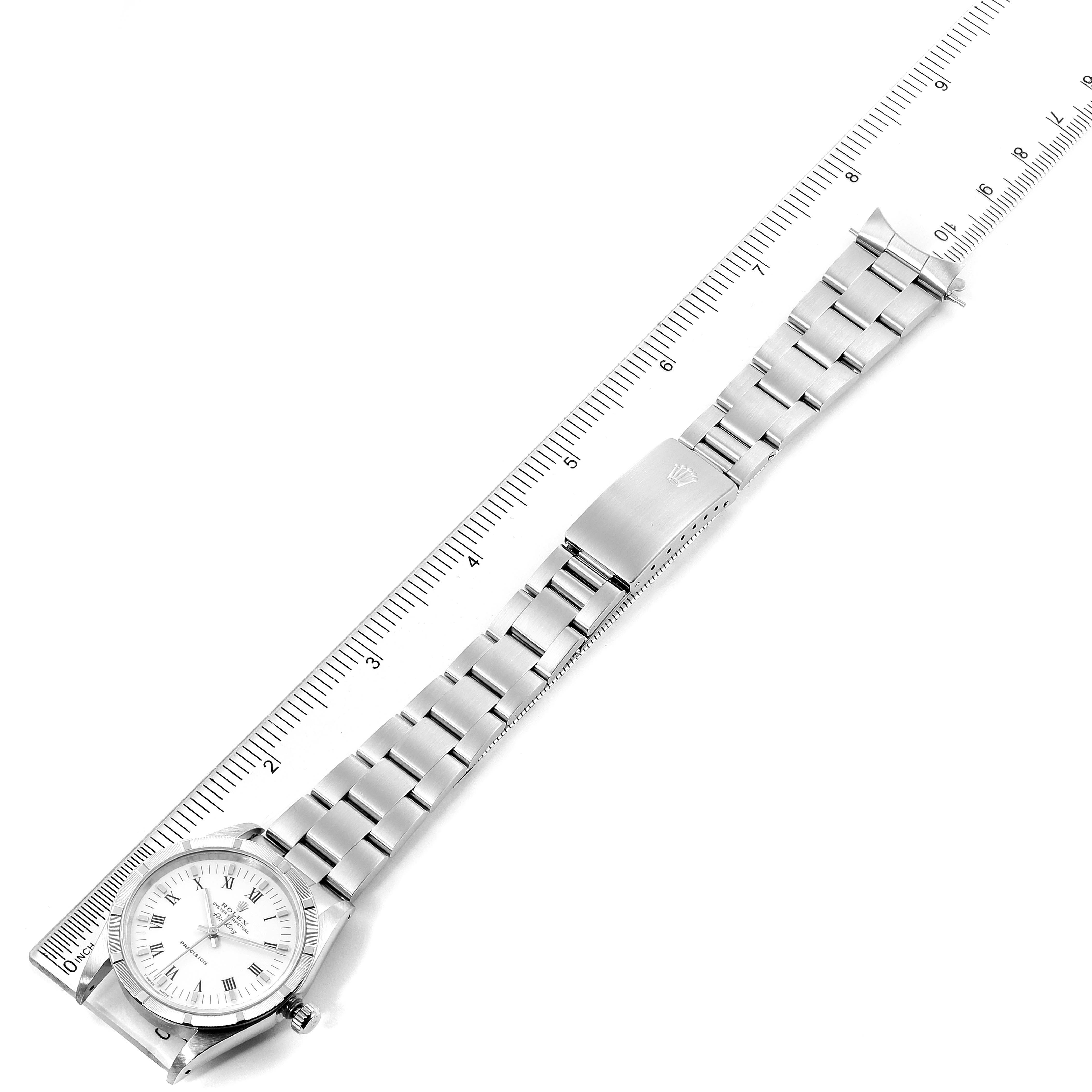 The Rolex Air-King 14010 Men's Stainless Steel White Dial 14010 Men's Stainless Steel White Dial watch is shown flat from above, with a ruler next to it displaying the face, bracelet, and clasp.