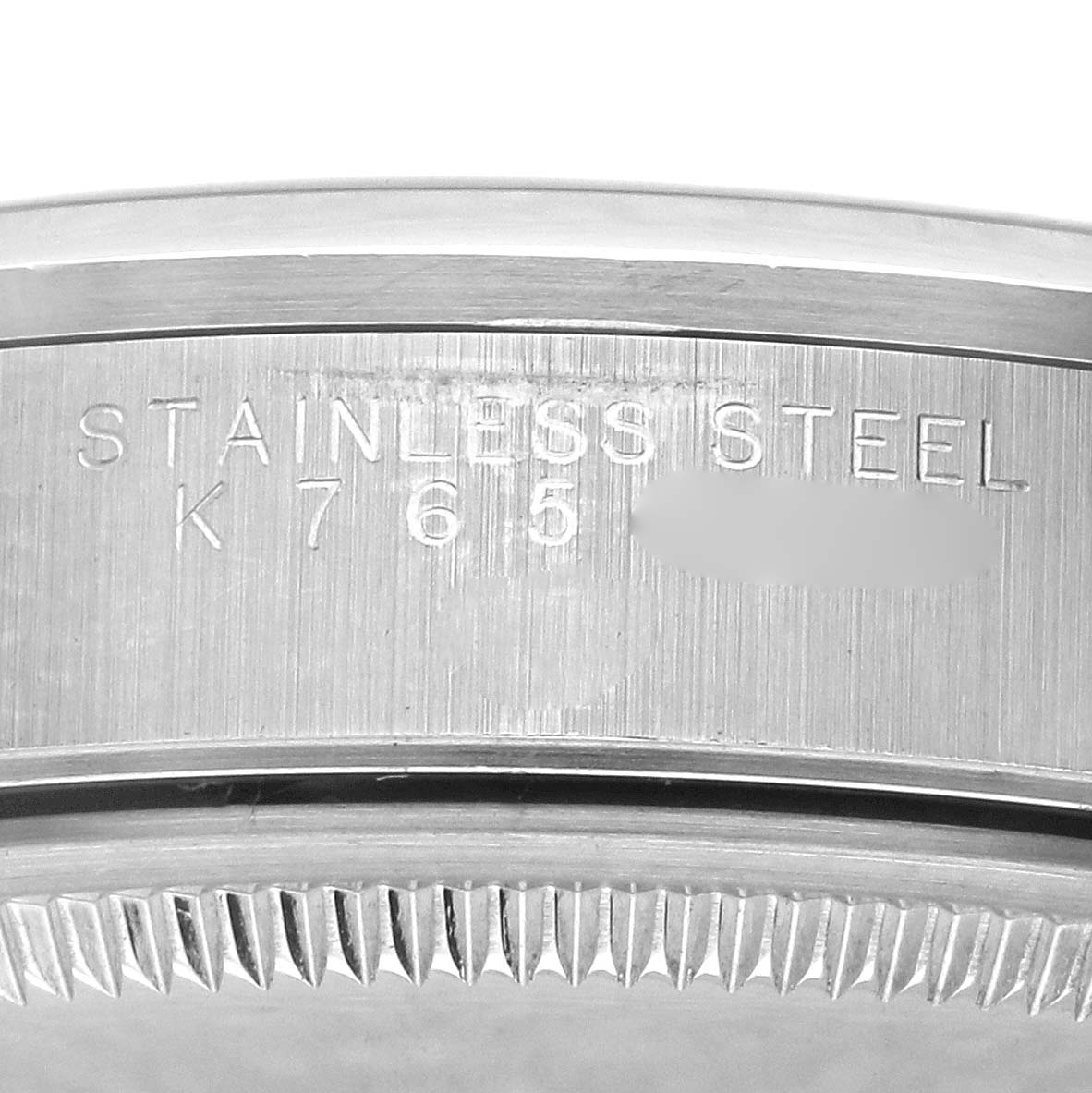 The image shows a close-up of the engraved case side of the Rolex Air-King 14000M Men's Stainless Steel Black Dial 14000M Men's Stainless Steel Black Dial, focusing on the stainless steel material.