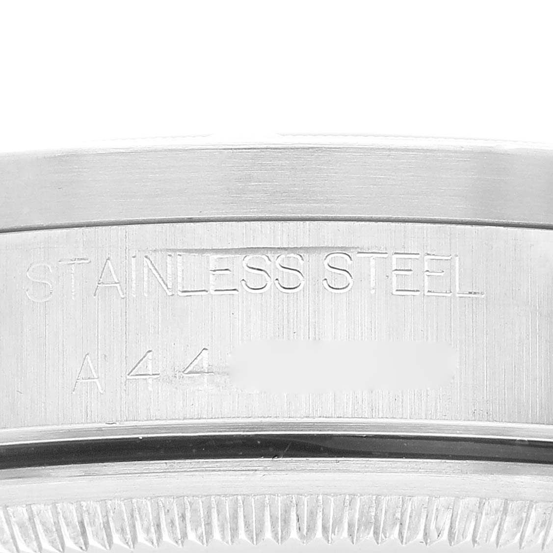 This image shows a close-up view of the case side of a Rolex Air-King 14010 Men's Stainless Steel Blue Dial 14010 Men's Stainless Steel Blue Dial watch with "STAINLESS STEEL" engraved.
