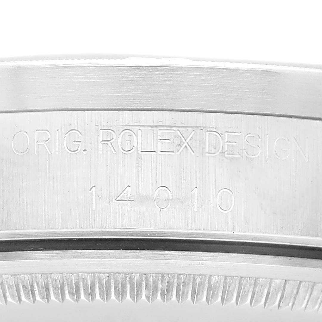 The image shows a close-up of the side of a Rolex Air-King 14010 Men's Stainless Steel Blue Dial 14010 Men's Stainless Steel Blue Dial watch case, featuring the engraved model number and "Orig. Rolex Design."