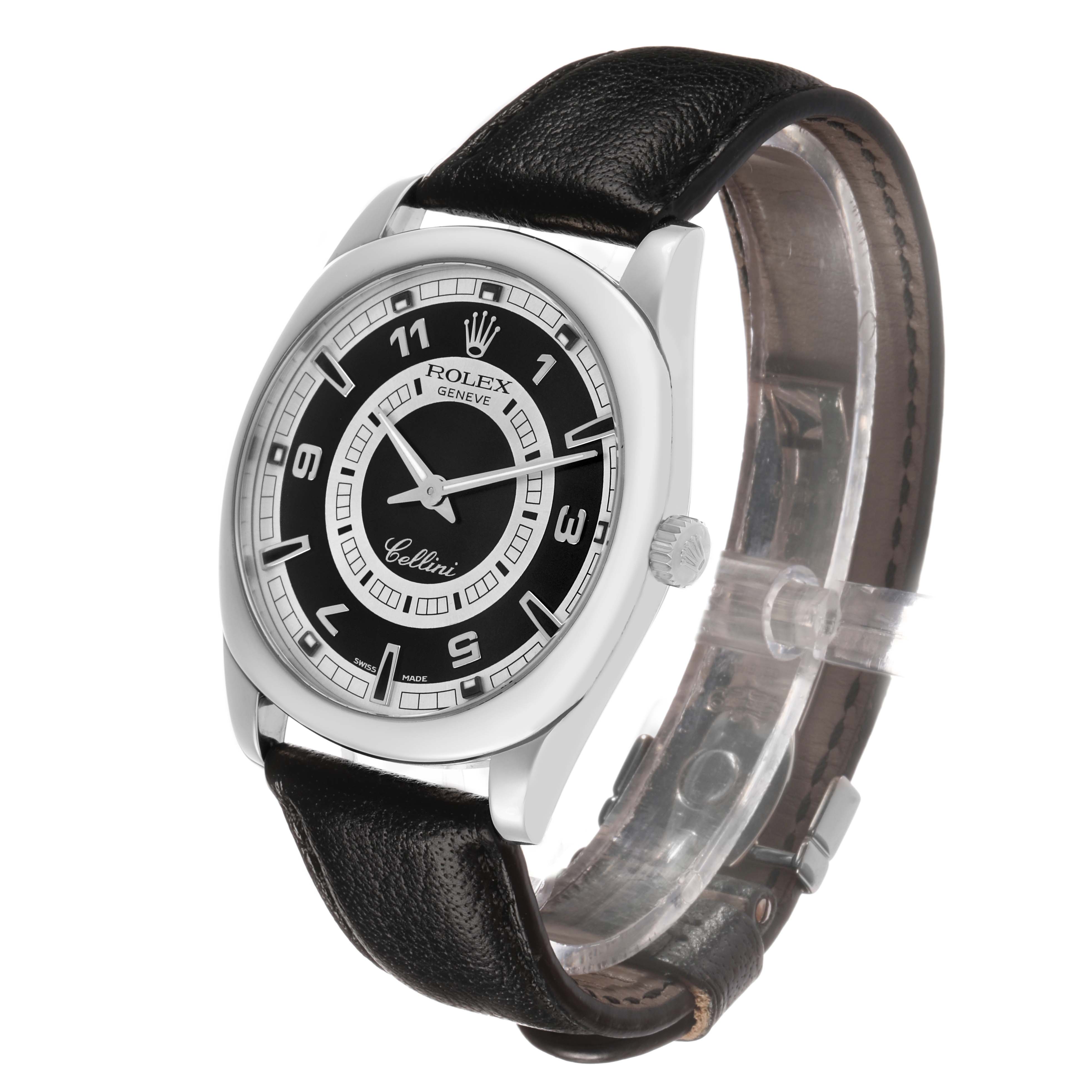 The Rolex Cellini 4243 Men's White Gold Black Dial watch is shown at an angled front view, displaying its face, case, crown, and leather strap.