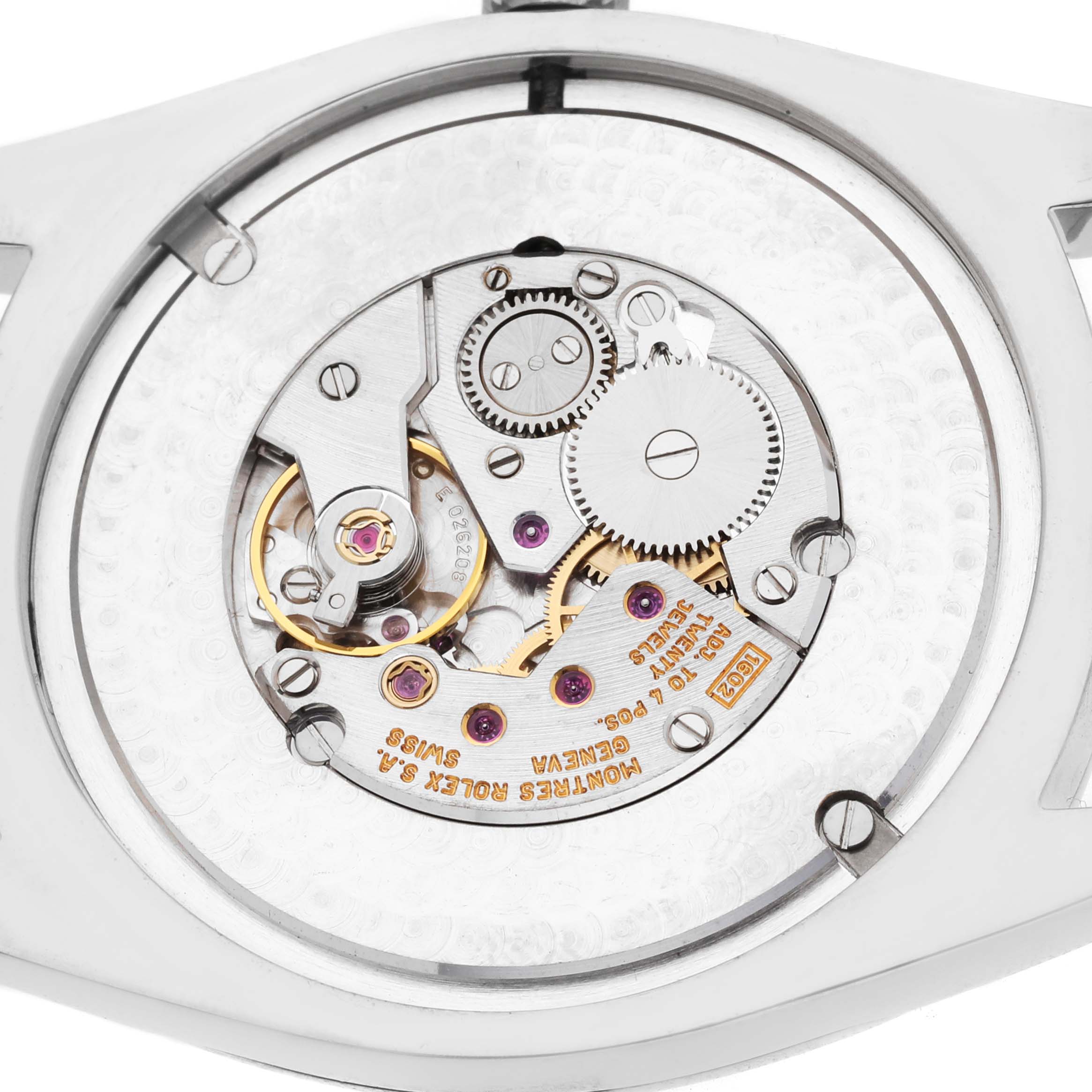 The image shows a close-up of the Rolex Cellini 4243 Men's White Gold Black Dial watch's movement from the back, highlighting gears and inscriptions.