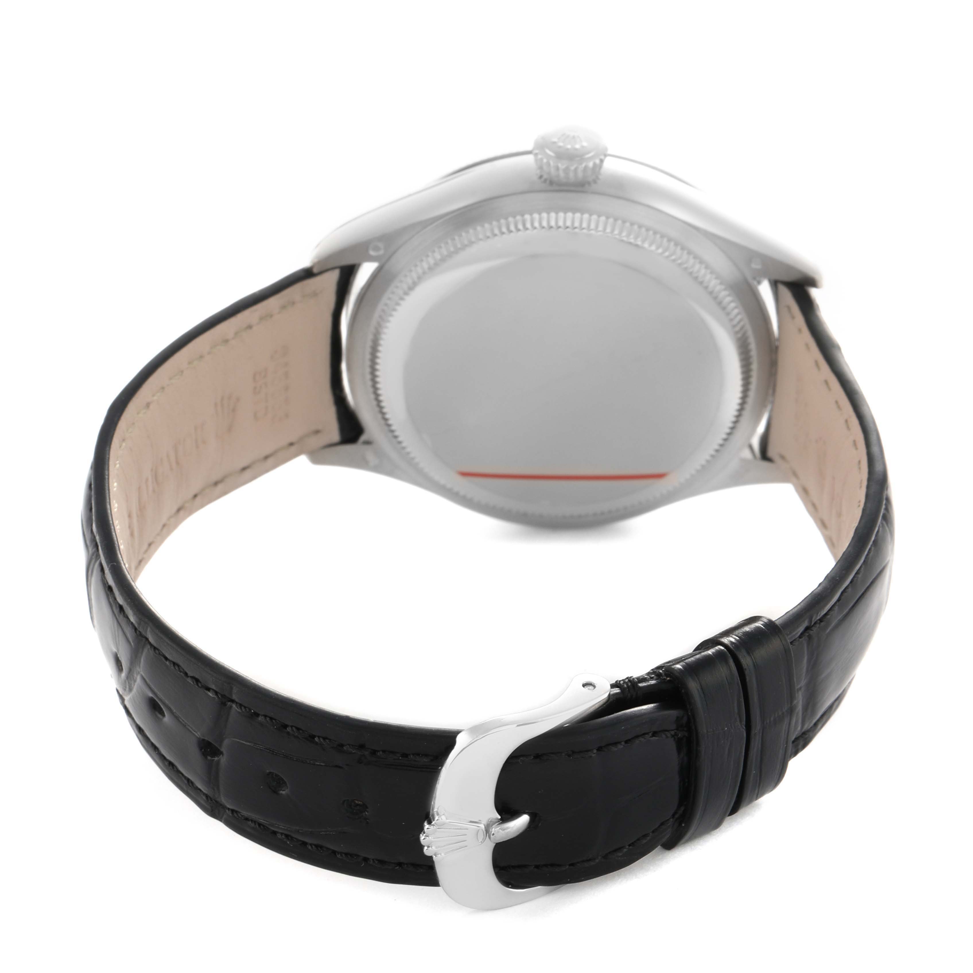 The Rolex Cellini 50509 Men's White Gold Black Dial watch is shown from the back, highlighting the case, crown, and black leather strap with a clasp.