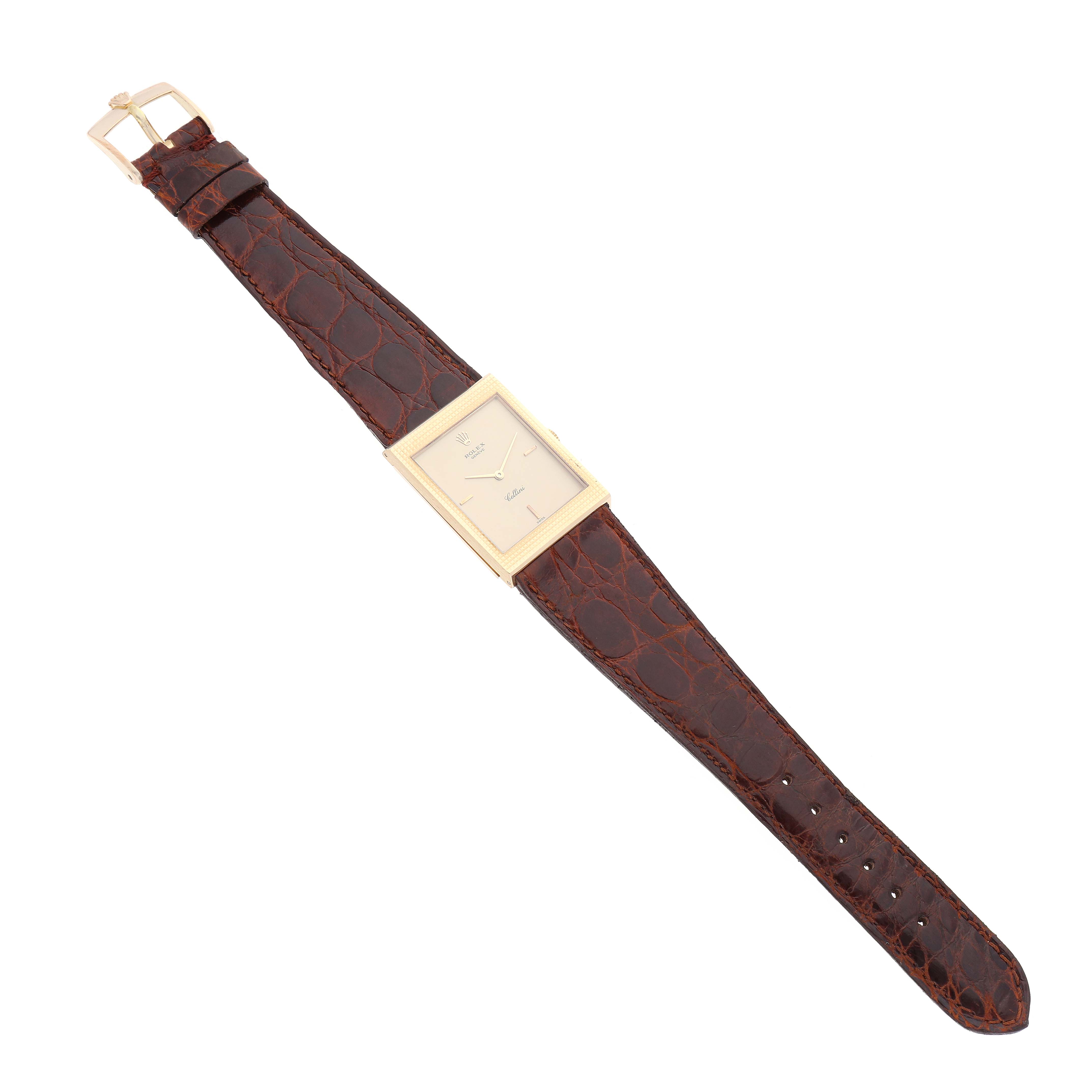 The Rolex Vintage Collection 4127 Men's Yellow Gold Champagne Dial 4127 Men's Yellow Gold Champagne Dial watch is shown from a top-down angle, displaying its brown leather strap and rectangular gold case.