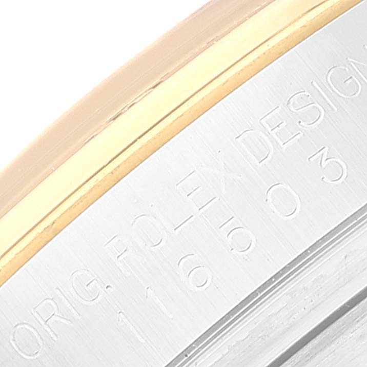 The image shows a close-up of the engraved markings on the side of the bezel of a Rolex Daytona 116503 Men's Steel and Gold (two tone) Champagne Dial 116503 Men's Steel and Gold (two tone) Champagne Dial watch.