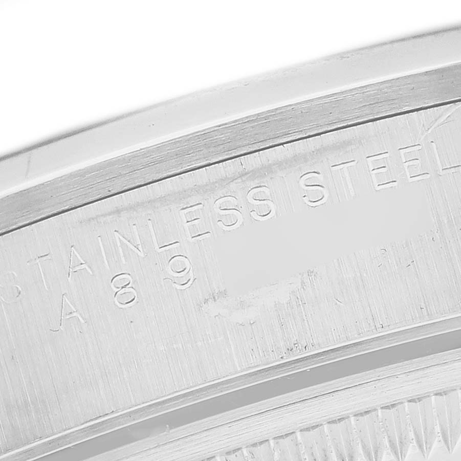 The image shows a close-up of the stainless steel casing of a Rolex Date 15200 Men's Stainless Steel Black Dial 15200 Men's Stainless Steel Black Dial model, focusing on the engraved serial number.