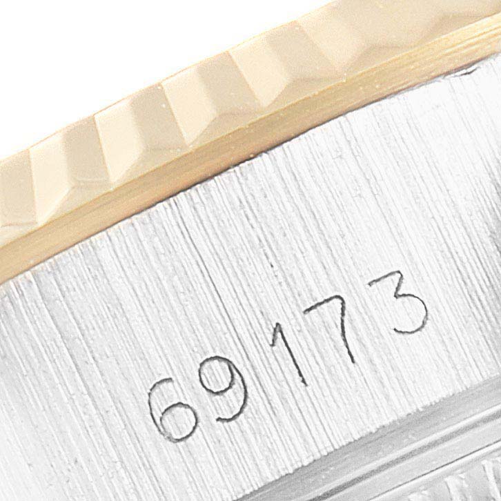 This close-up shows the side of a Rolex Datejust 69173 Women
s Steel and Gold (two tone) Champagne Dial 69173 Women
s Steel and Gold (two tone) Champagne Dial watch, highlighting the model number 69173 beneath the bezel.