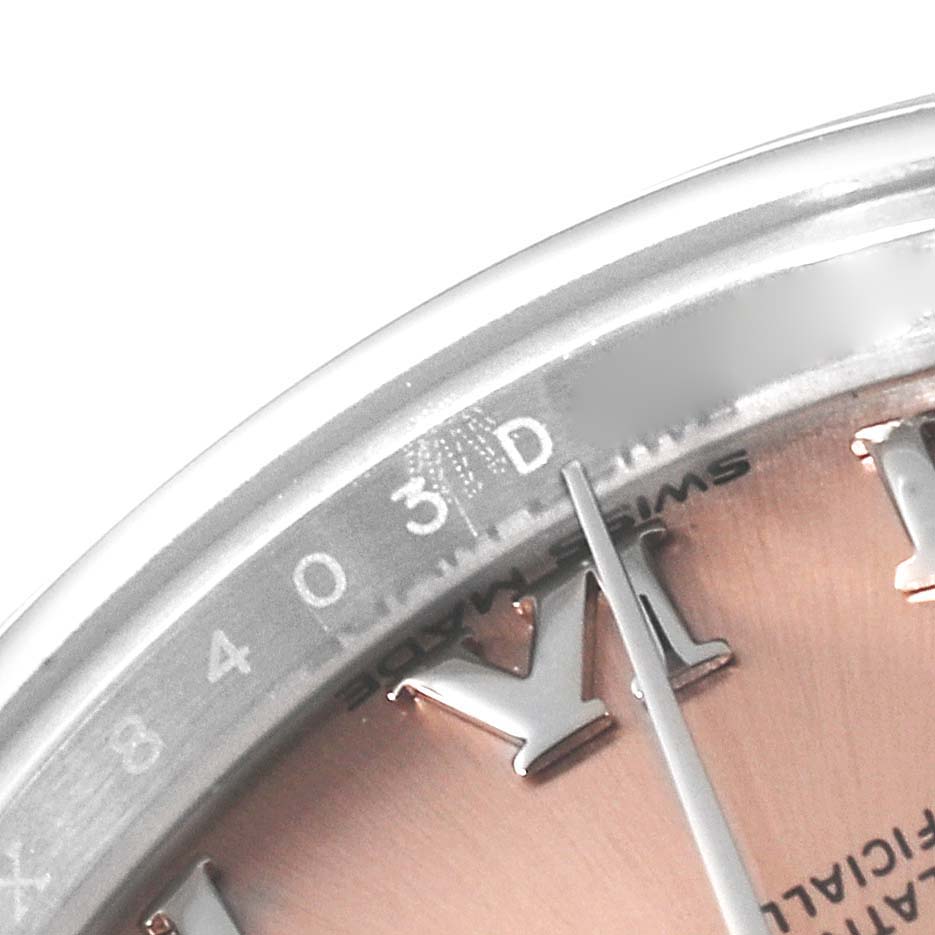 The image shows a close-up of the Rolex Datejust 279160 Women's Stainless Steel Pink Dial 279160 Women's Stainless Steel Pink Dial watch, highlighting the dial and partial bezel indicating the date and Roman numeral hour markers.