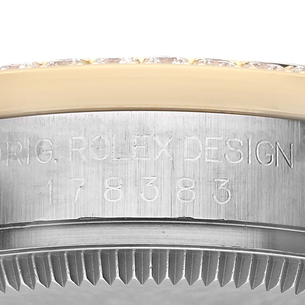 The image shows the side of a Rolex Mid-Size 178383 Women's Steel and Gold (two tone) Black Dial 178383 Women's Steel and Gold (two tone) Black Dial watch, focusing on the bezel and the engraved design number.