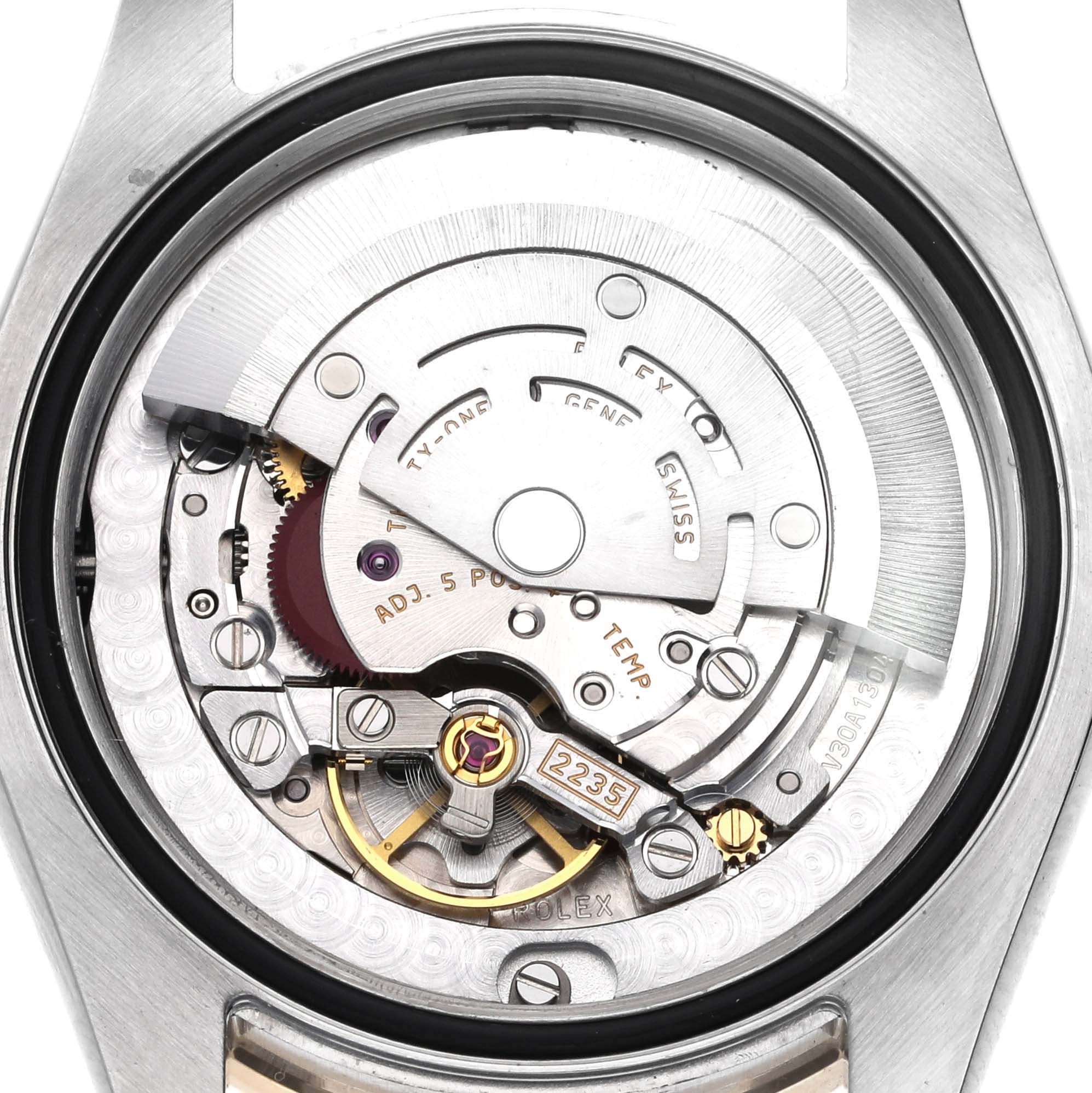 The image shows the movement of a Rolex Mid-Size 178383 Women's Steel and Gold (two tone) Black Dial 178383 Women's Steel and Gold (two tone) Black Dial watch from a rear angle, revealing its intricate internal components.