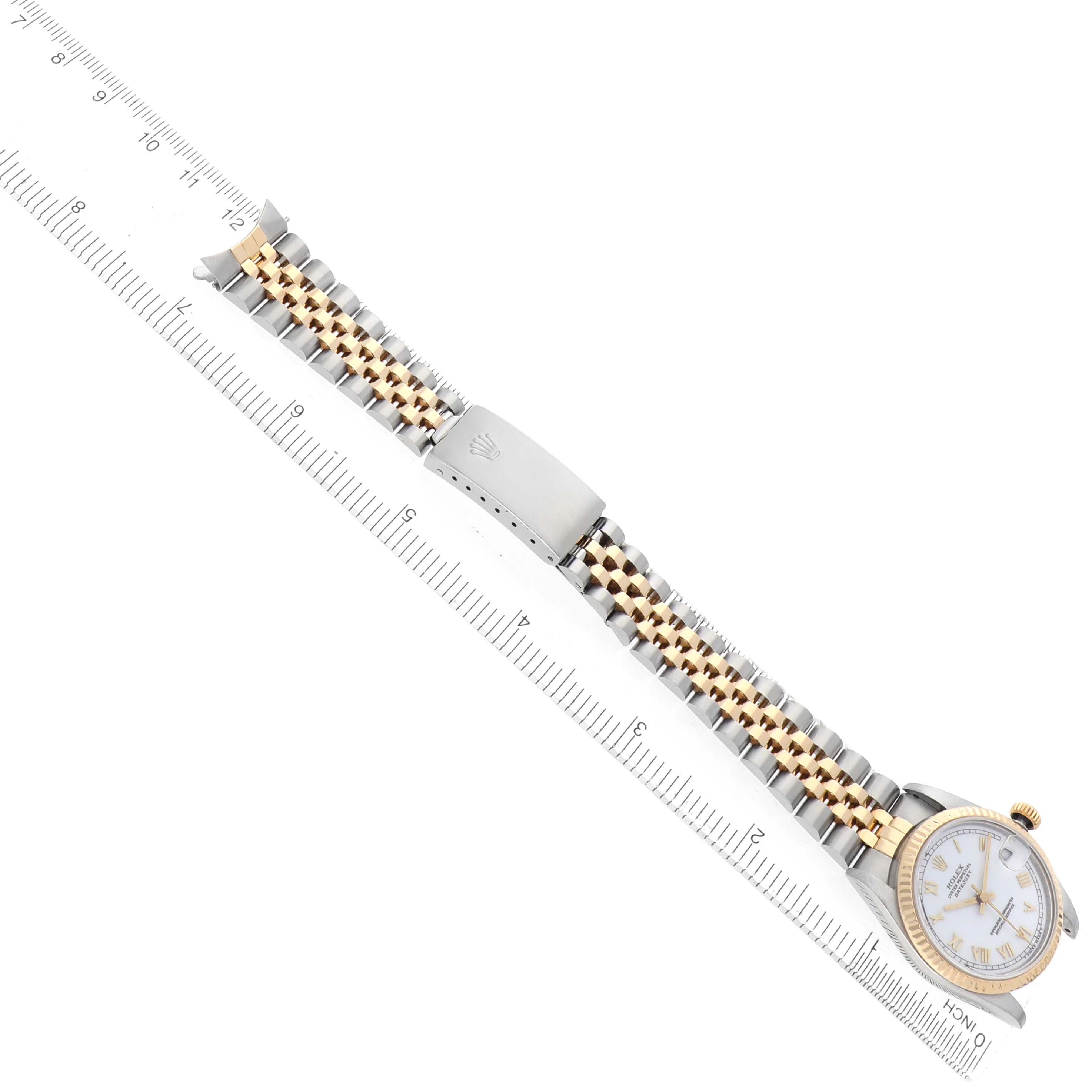 The image shows a Rolex Datejust 68273 Women's Steel and Gold (two tone) White Dial watch laid flat with its two-tone bracelet aligned next to a measuring ruler.