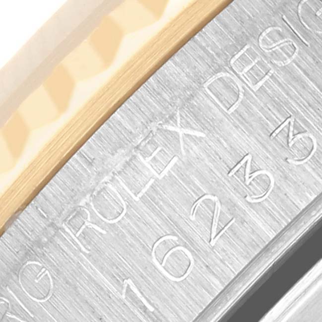 The image shows a close-up of the engraved inner case ring of a Rolex Datejust 16233 Men's Steel and Gold (two tone) Champagne Dial 16233 Men's Steel and Gold (two tone) Champagne Dial watch.