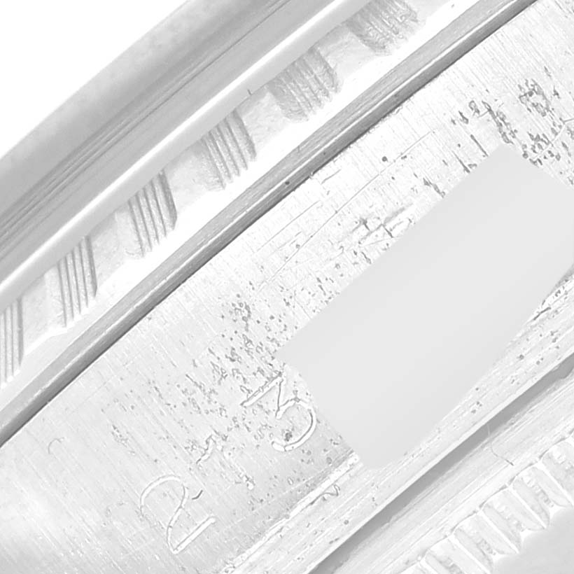 This close-up image shows the engraved details on the metal casing of a Rolex Vintage Collection 1603 Men's Stainless Steel Black Dial 1603 Men's Stainless Steel Black Dial watch.