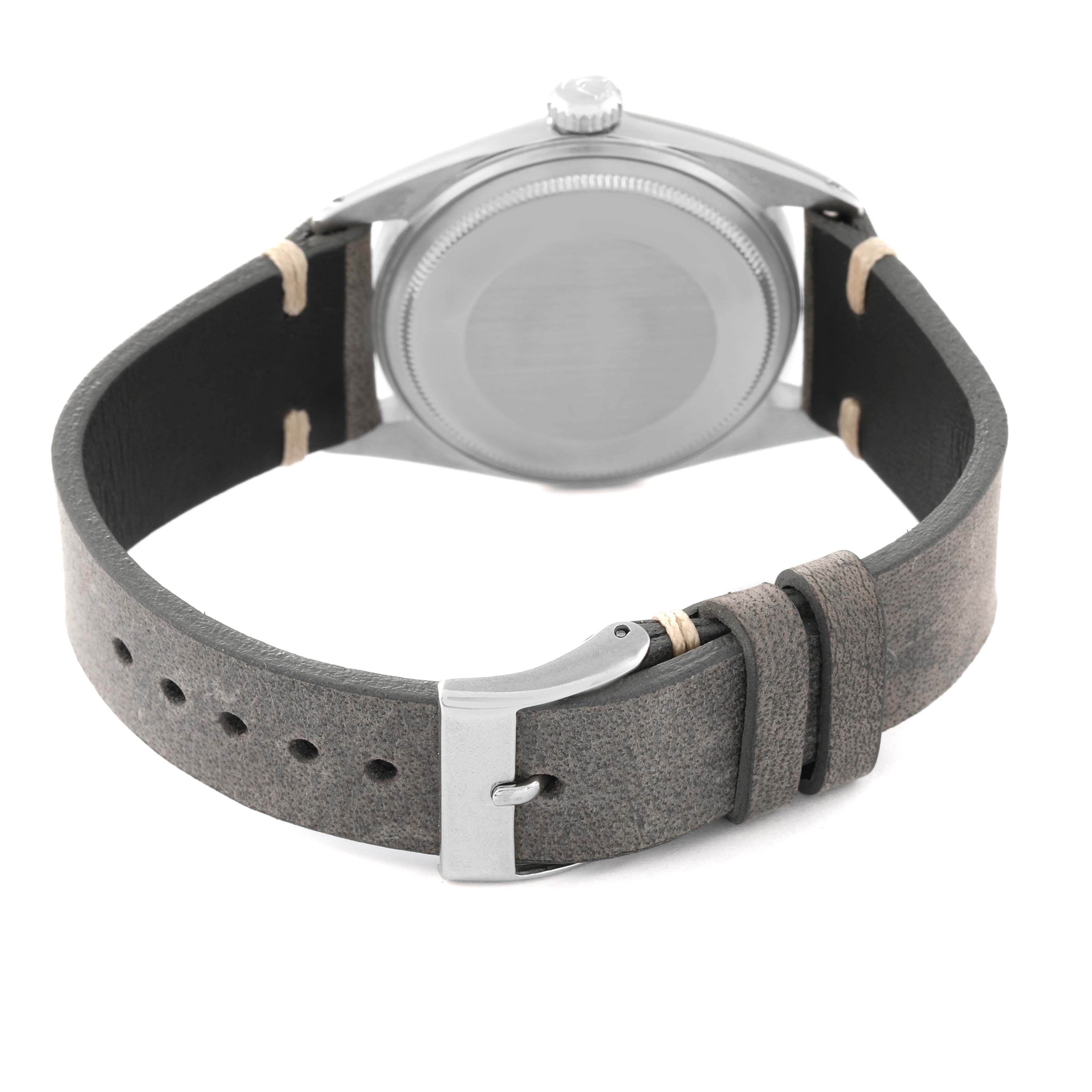 The image shows the back of a Rolex Vintage Collection 1603 Men's Stainless Steel Black Dial 1603 Men's Stainless Steel Black Dial model watch with a leather strap and buckle.