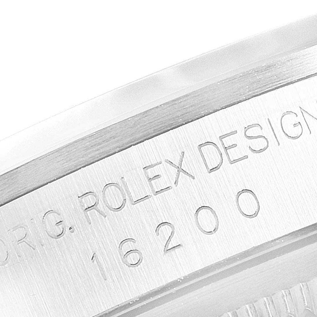 The image shows a partial view of the side of the bezel on a Rolex Datejust 16200 Men's Stainless Steel Black Dial 16200 Men's Stainless Steel Black Dial model, with engraved text and model number 16200.