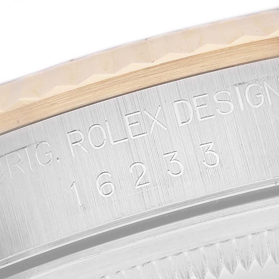 This close-up image shows the side engraving and part of the bezel of a Rolex Datejust 16233 Men's Steel and Gold (two tone) Blue Dial 16233 Men's Steel and Gold (two tone) Blue Dial watch.