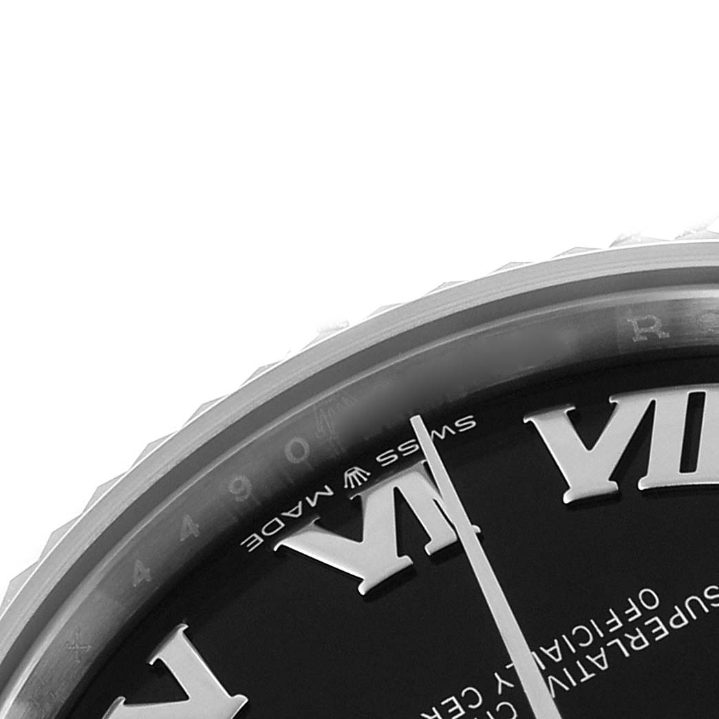 The image shows a close-up of the Rolex Mid-Size 278274 Women's Stainless Steel Black Dial watch, focusing on part of the dial with Roman numerals and the edge of the bezel.