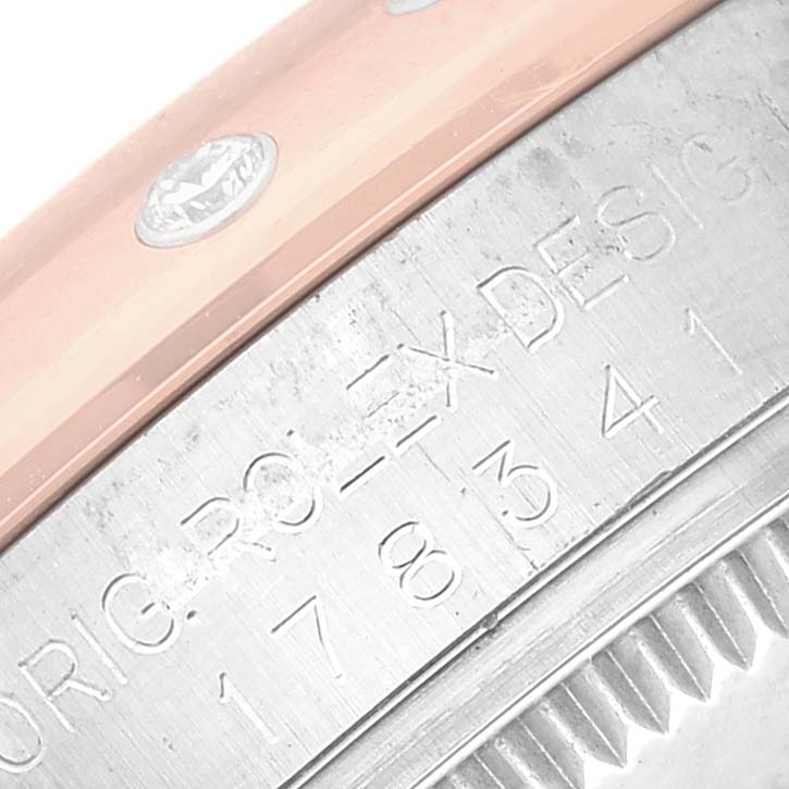 The image shows a close-up of the side of a Rolex Mid-Size 178341 Women's Steel and Gold (two tone) Brown Dial 178341 Women's Steel and Gold (two tone) Brown Dial model, highlighting the engraved serial number and part of the bezel.