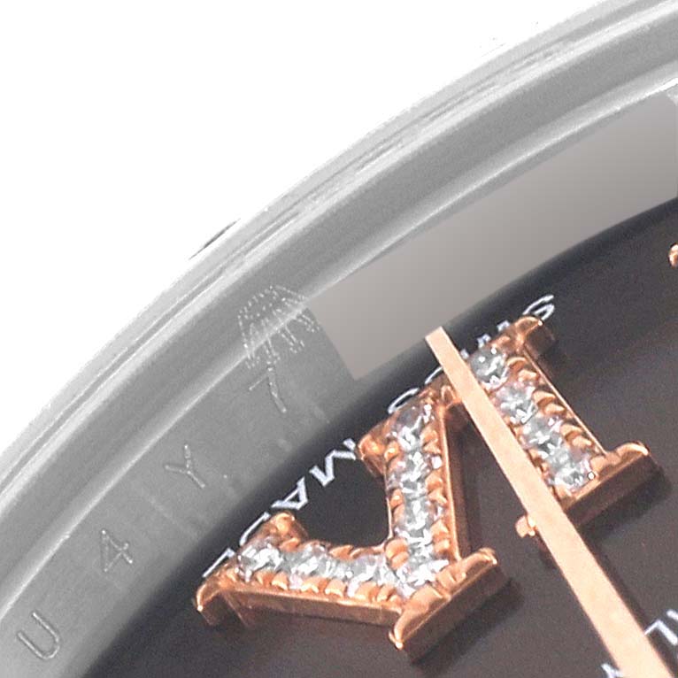 The image shows a close-up angle of the dial and bezel of a Mid-Size Rolex watch, featuring a diamond-encrusted Roman numeral.