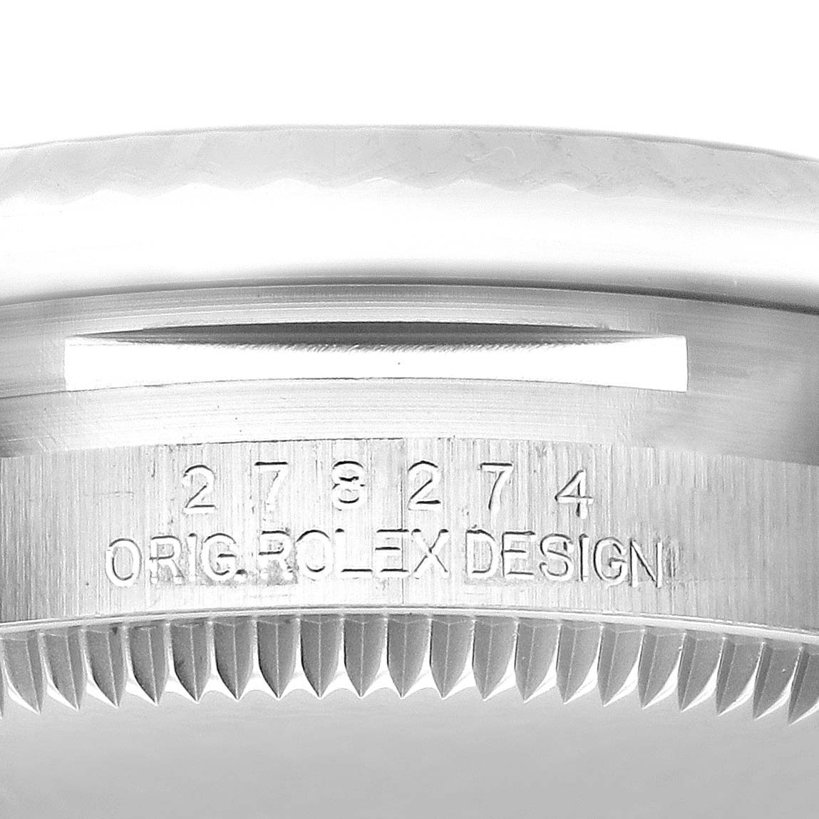 The image shows a close-up of the edge and outer casing of a mid-size Rolex watch with engraved details.