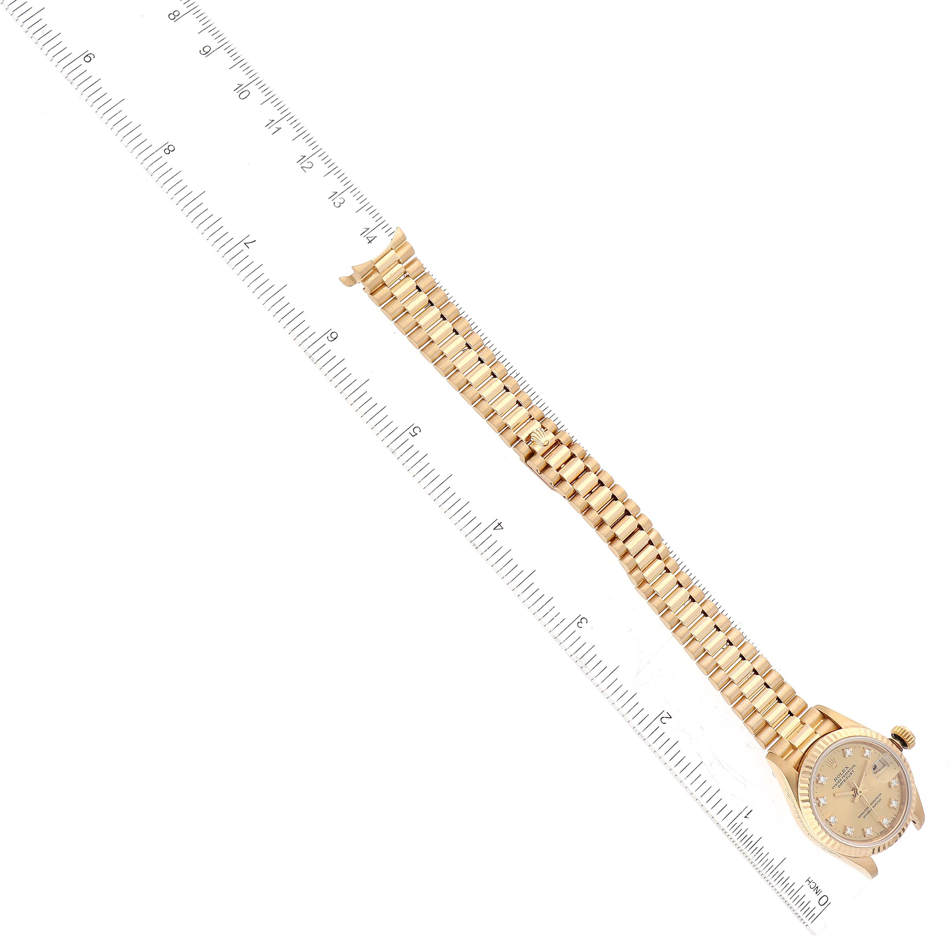 The Rolex President 69178 Women's Yellow Gold Champagne Dial 69178 Women's Yellow Gold Champagne Dial model is shown laid flat, fully extended with a ruler measuring its length from end to end.