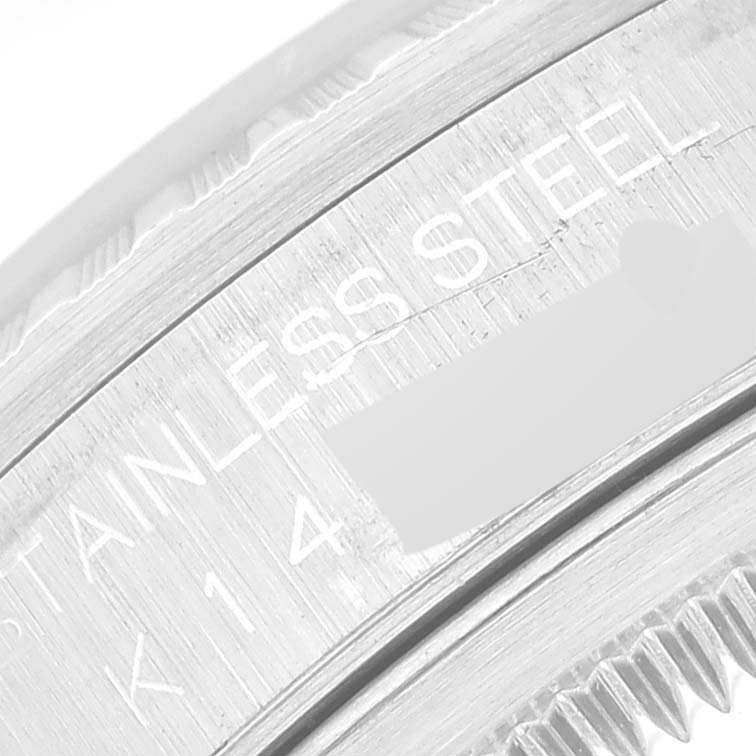 This close-up shows the side engraving of the bezel and part of the rehaut of a Rolex Datejust 16220 Men's Stainless Steel Silver Dial 16220 Men's Stainless Steel Silver Dial watch.