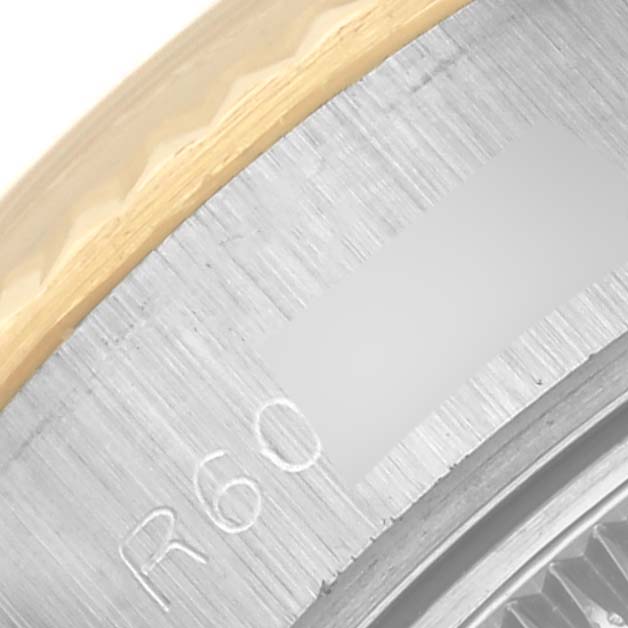 The image shows a close-up of the bezel and outer edge of the Rolex Datejust 69173 Women's Steel and Gold (two tone) Silver Dial 69173 Women's Steel and Gold (two tone) Silver Dial watch, highlighting its materials and engravings.