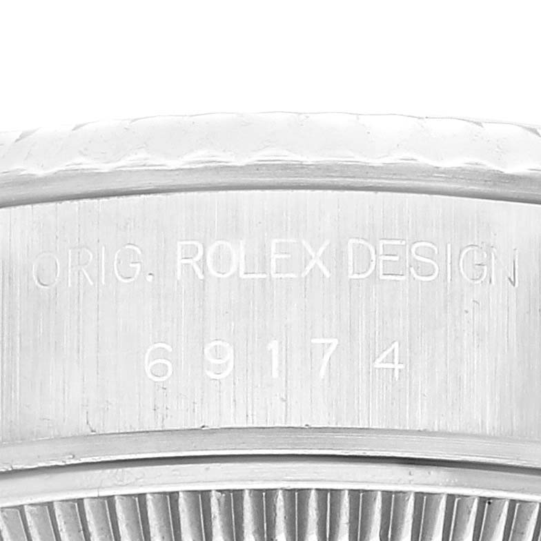 The image shows a close-up of the caseback and serial number engraving of a Rolex Datejust 69174 Women's Stainless Steel Blue Dial 69174 Women's Stainless Steel Blue Dial watch.