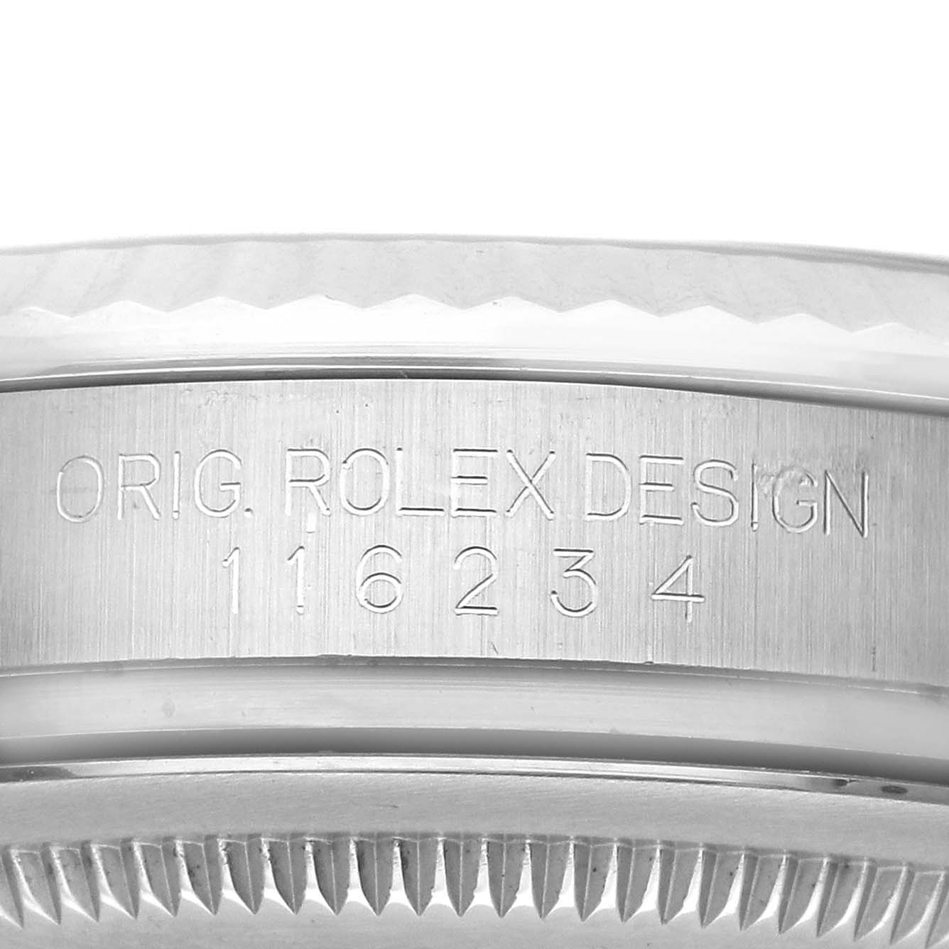 The image shows the side of a Rolex Datejust 116234 Men's Stainless Steel Blue Dial 116234 Men's Stainless Steel Blue Dial model with the engraved serial number and part of the bezel from a side angle.