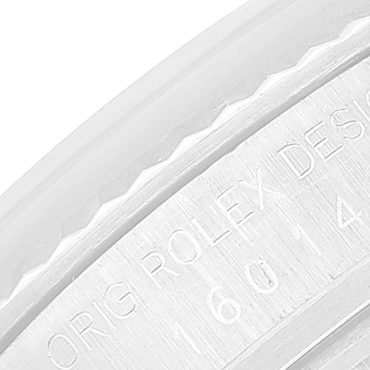 This image shows a close-up of the engraving on the side of the bezel of a Rolex Datejust 16014 Men's Stainless Steel Silver Dial 16014 Men's Stainless Steel Silver Dial watch.