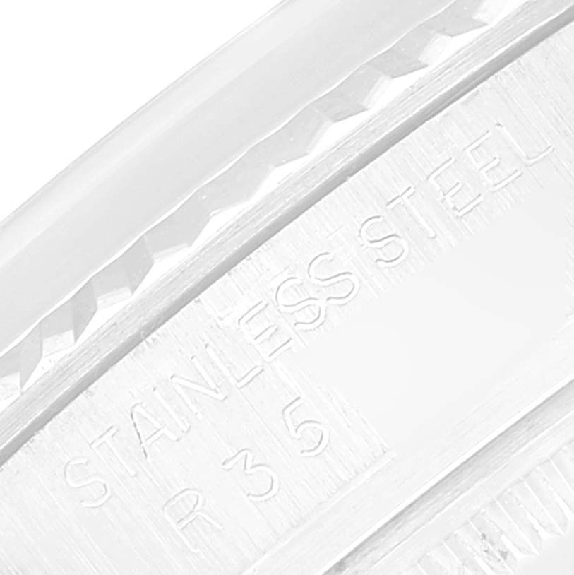 The image shows an extreme close-up of the outer edge and engraving on the stainless steel bezel of a Rolex Datejust 16014 Men's Stainless Steel Silver Dial 16014 Men's Stainless Steel Silver Dial watch.