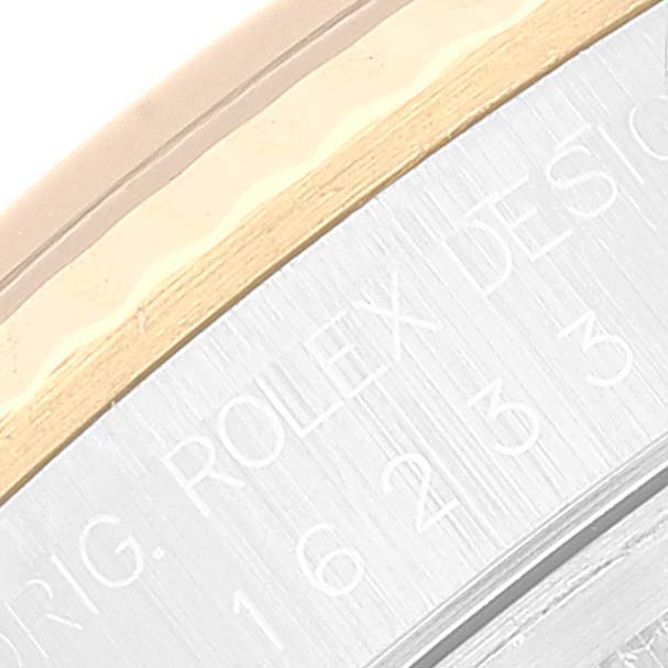 This image shows a close-up of the engraved outer rim of the Rolex Datejust 16233 Men's Steel and Gold (two tone) Blue Dial 16233 Men's Steel and Gold (two tone) Blue Dial watch.