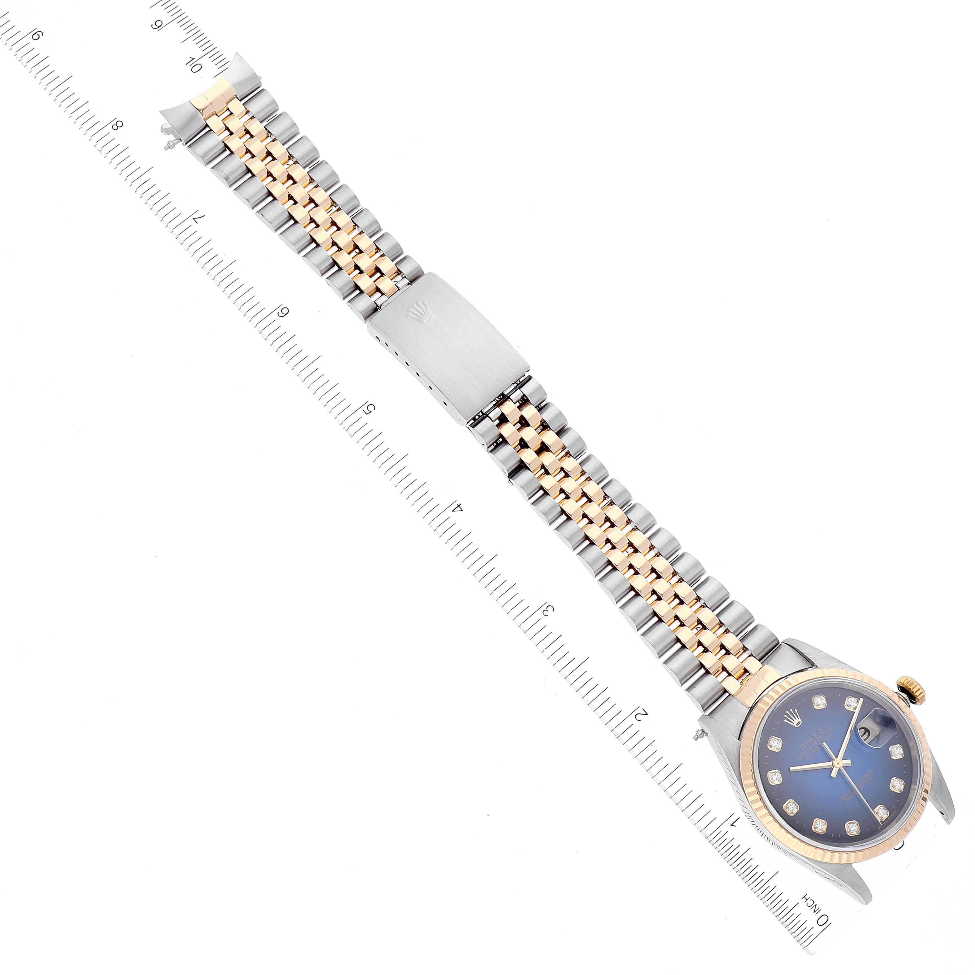 This image shows a top-down view of a Rolex Datejust 16233 Men's Steel and Gold (two tone) Blue Dial 16233 Men's Steel and Gold (two tone) Blue Dial watch, highlighting its Jubilee bracelet, dial, and clasp.