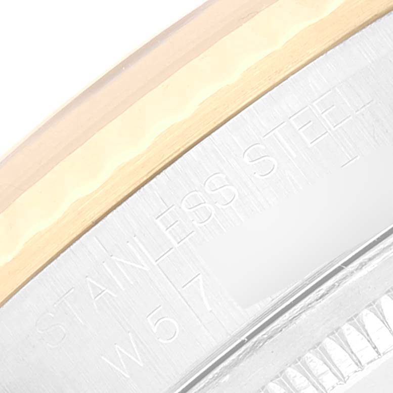 The image shows a close-up of the Rolex Datejust 16233 Men's Steel and Gold (two tone) Blue Dial 16233 Men's Steel and Gold (two tone) Blue Dial model's bezel and engraved stainless steel text.