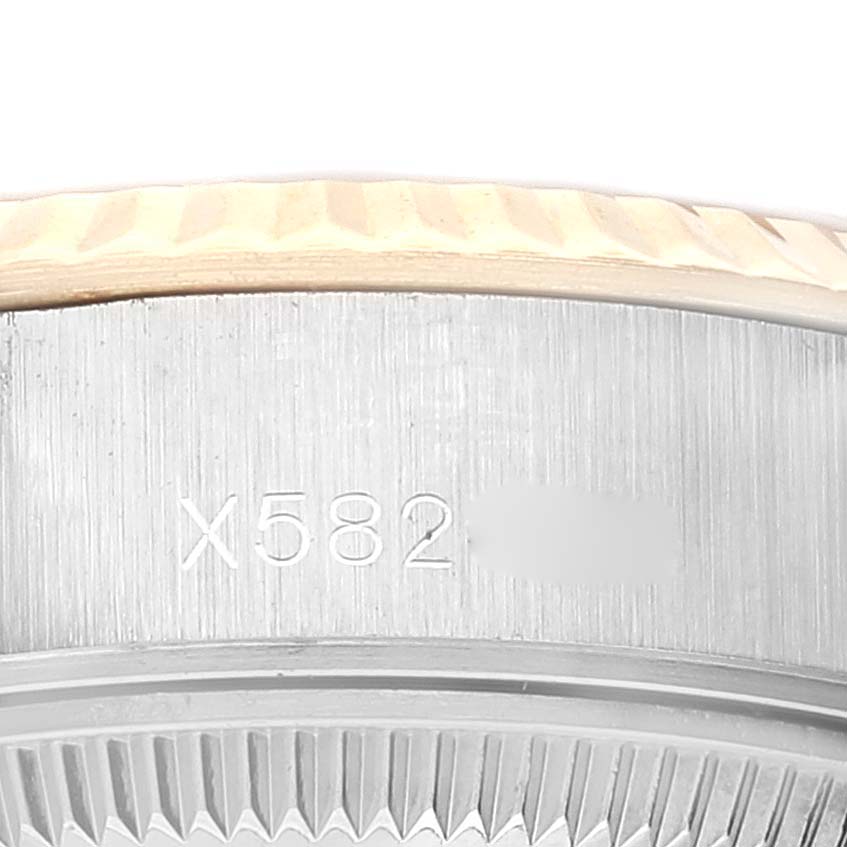 This close-up image of a Rolex Datejust 69173 Women's Steel and Gold (two tone) Champagne Dial 69173 Women's Steel and Gold (two tone) Champagne Dial watch shows the engraved model number on the side of the case under the bezel.
