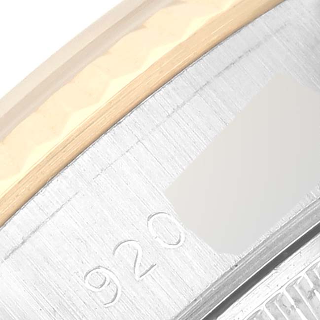 This image shows a close-up of the side of a Rolex Datejust 69173 Women's Steel and Gold (two tone) Champagne Dial 69173 Women's Steel and Gold (two tone) Champagne Dial watch, focusing on the edge of the bezel and part of the case with engraved markings.