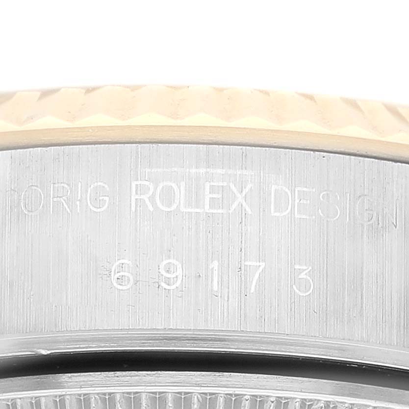 The image shows a close-up of the side casing with engravings on a Rolex Datejust 69173 Women's Steel and Gold (two tone) Champagne Dial 69173 Women's Steel and Gold (two tone) Champagne Dial watch.