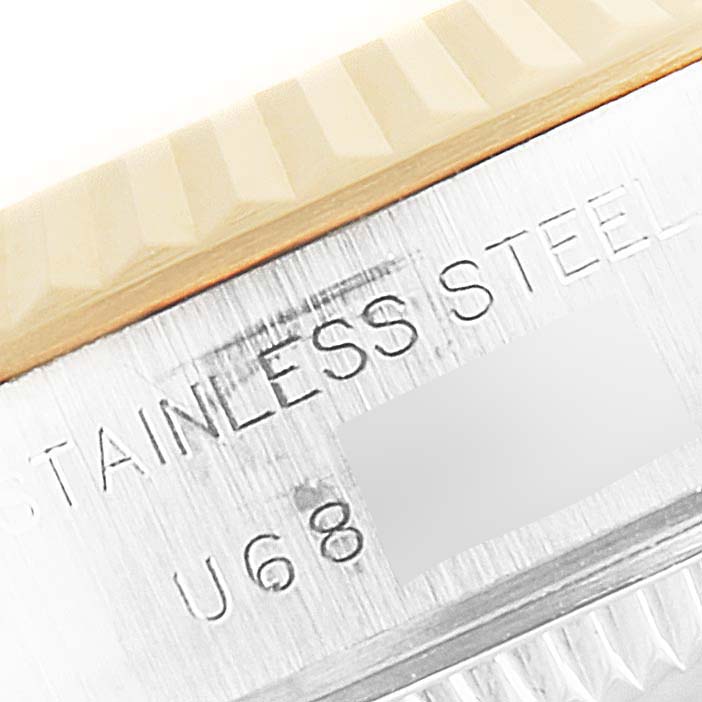 The image shows a close-up of the side of a Rolex Datejust 69173 Women
s Steel and Gold (two tone) Champagne Dial 69173 Women
s Steel and Gold (two tone) Champagne Dial, highlighting the "STAINLESS STEEL" engraving.