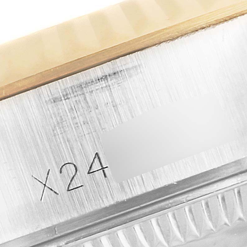 The image shows a close-up of the case side with a partial serial number engraving on a Rolex Datejust 69173 Women
s Steel and Gold (two tone) Champagne Dial 69173 Women
s Steel and Gold (two tone) Champagne Dial watch.