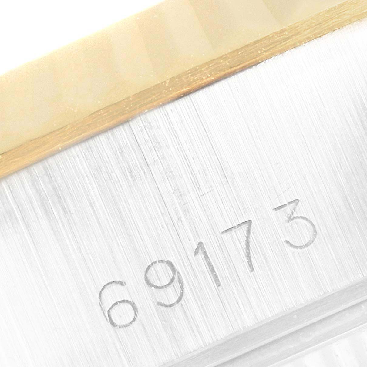 This close-up image shows the model number "69173" engraved on the side of a Rolex Datejust 69173 Women
s Steel and Gold (two tone) Champagne Dial 69173 Women
s Steel and Gold (two tone) Champagne Dial watch case.