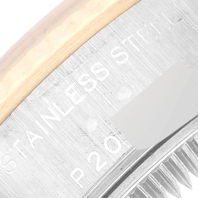 The close-up image of the Rolex Datejust 79173 Women's Steel and Gold (two tone) White Dial 79173 Women's Steel and Gold (two tone) White Dial watch shows part of the bezel and case with "STAINLESS STEEL" engraving.