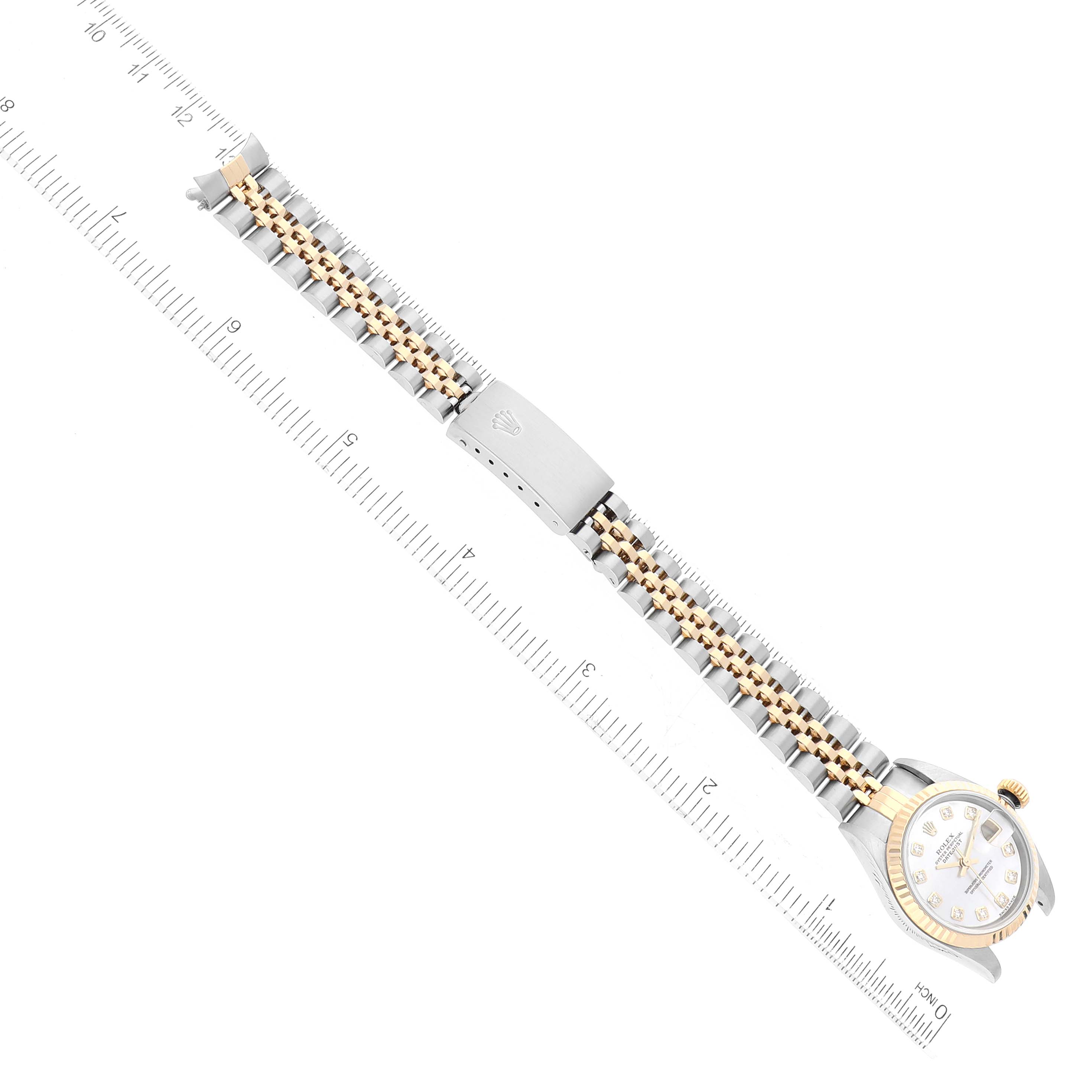 The image shows a top-down view of a Rolex Datejust 79173 Women's Steel and Gold (two tone) Mother of Pearl Dial 79173 Women's Steel and Gold (two tone) Mother of Pearl Dial watch, highlighting its dial, bezel, bracelet, and clasp along with a measuring scale.