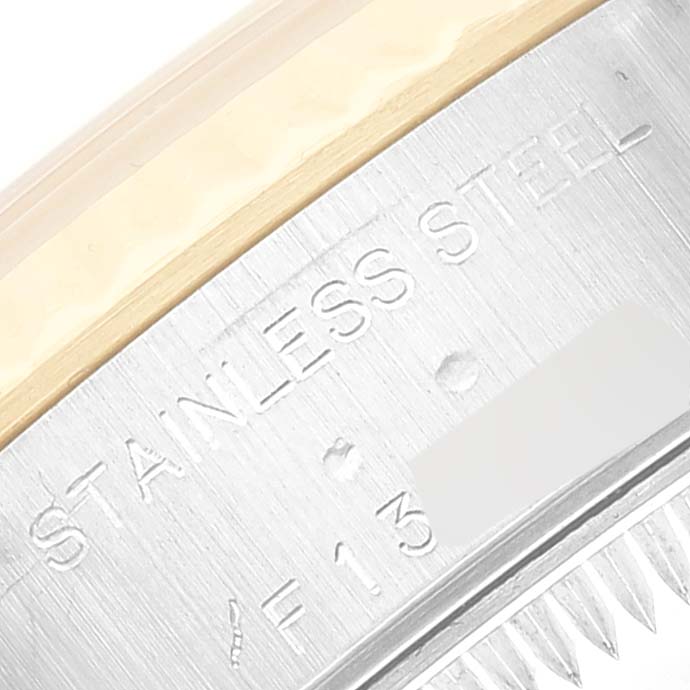 This image shows the side engraving of a stainless steel casing of a Rolex Datejust 79173 Women's Steel and Gold (two tone) Mother of Pearl Dial 79173 Women's Steel and Gold (two tone) Mother of Pearl Dial watch.