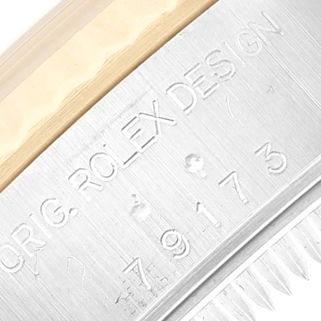 This image shows a close-up of the case engraving and part of the bezel on a Rolex Datejust 79173 Women's Steel and Gold (two tone) Mother of Pearl Dial 79173 Women's Steel and Gold (two tone) Mother of Pearl Dial watch.