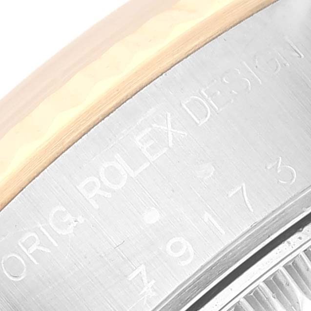 The image shows a close-up of the case back of a Rolex Datejust 79173NR Women's Steel and Gold (two tone) Mother of Pearl Dial 79173NR Women's Steel and Gold (two tone) Mother of Pearl Dial, highlighting the engraved text and part of the bezel.