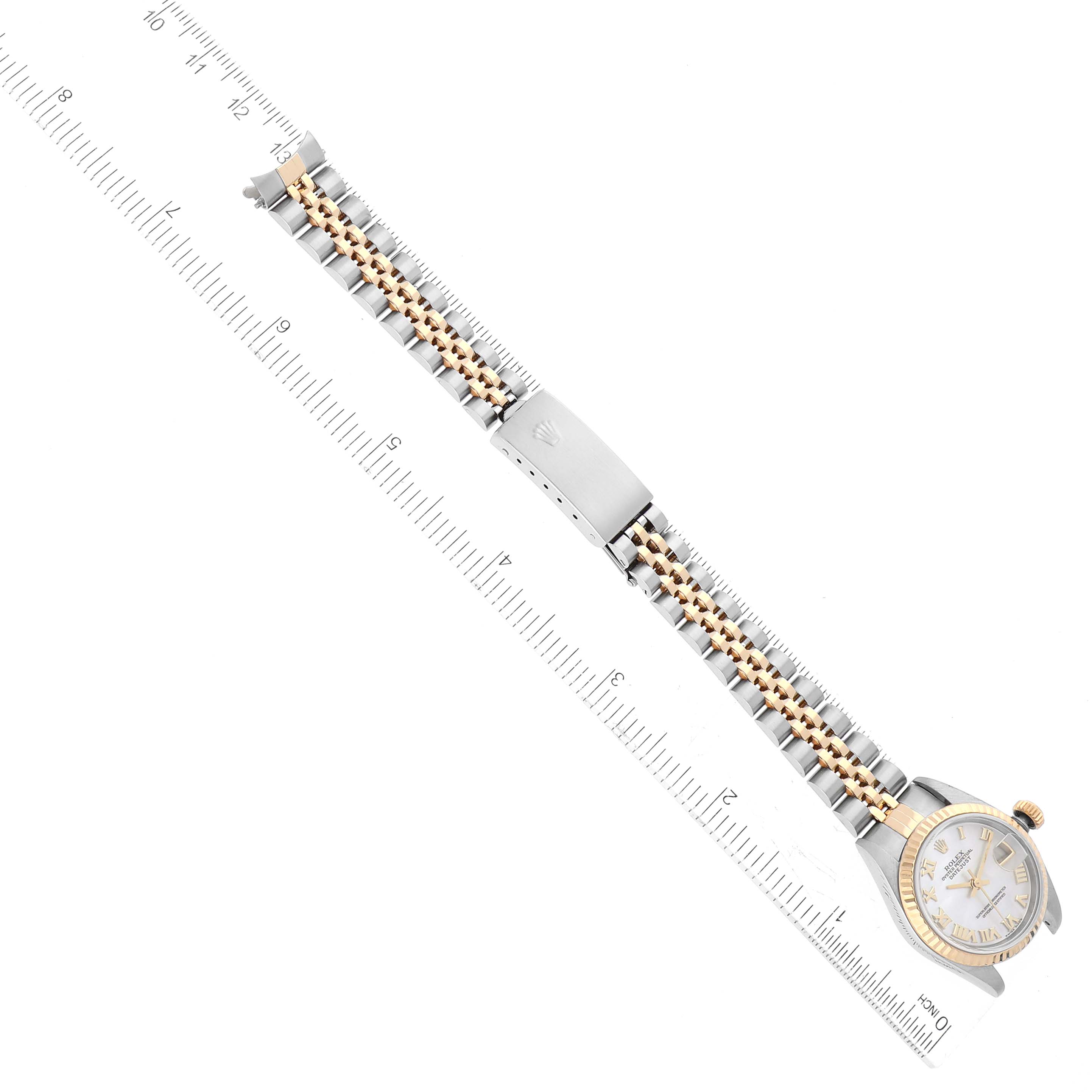 The image shows a top view of a Rolex Datejust 79173NR Women's Steel and Gold (two tone) Mother of Pearl Dial 79173NR Women's Steel and Gold (two tone) Mother of Pearl Dial watch, focusing on the watch face, bracelet, and clasp, with a ruler for scale.