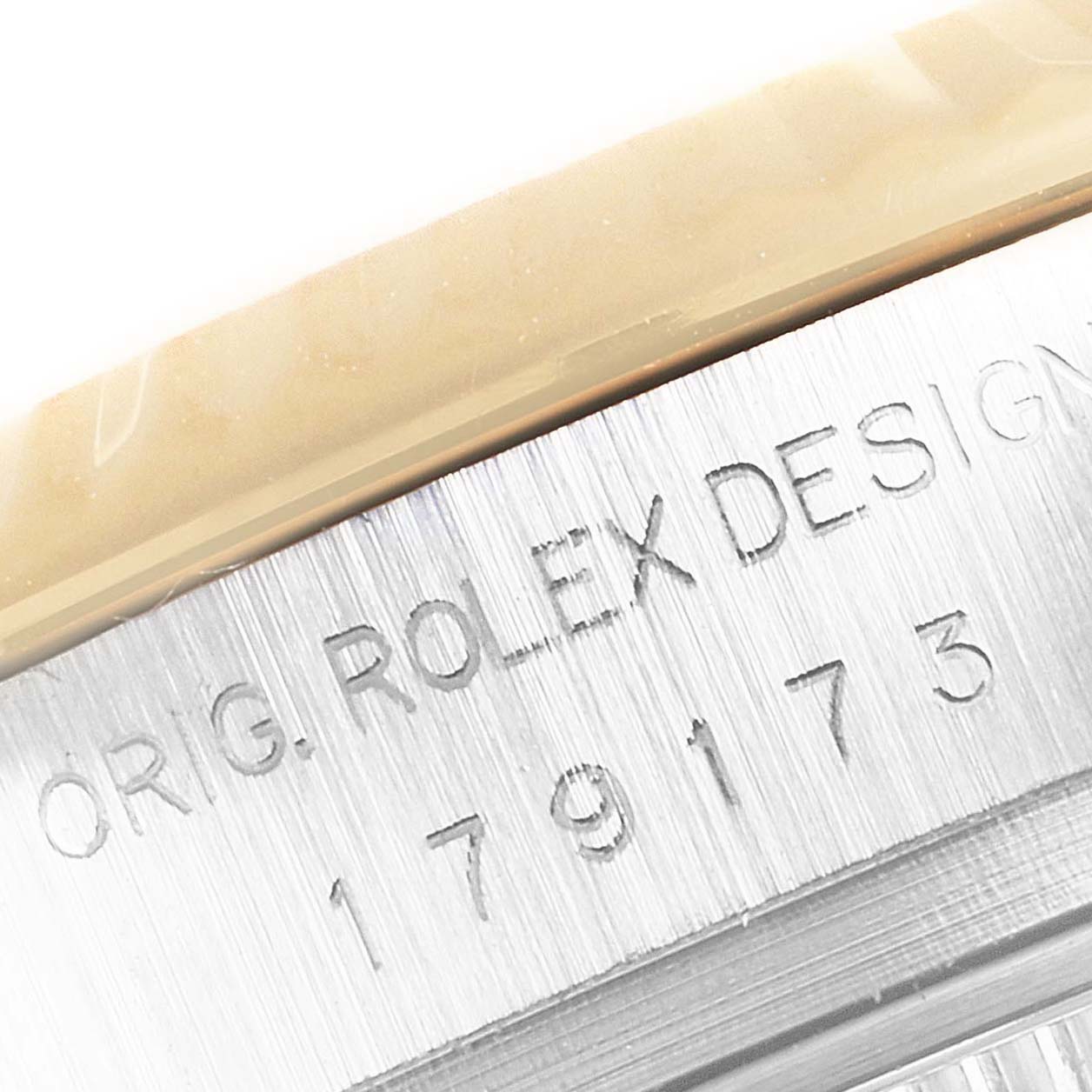 The image shows a close-up of the engraved case back of a Rolex Datejust 179173 Women
s Steel and Gold (two tone) Mother of Pearl Dial 179173 Women
s Steel and Gold (two tone) Mother of Pearl Dial watch.