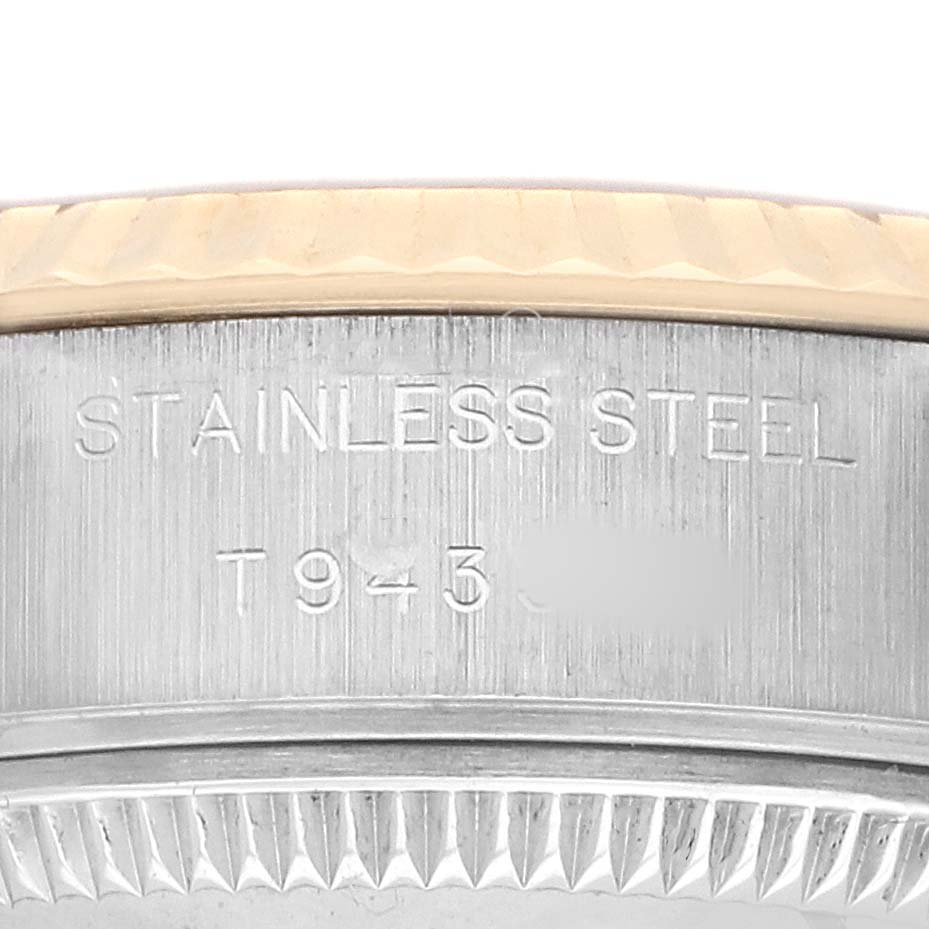 The image shows the side of the case of a Rolex Datejust 69173 Women's Steel and Gold (two tone) Champagne Dial, featuring the stainless steel engraving and part of the bezel.
